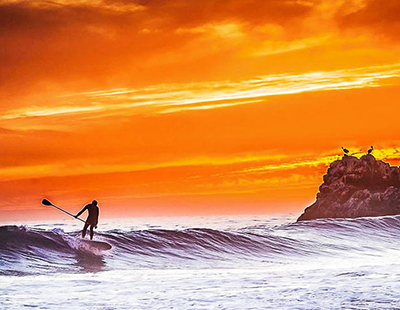 SUP surfing at sunset